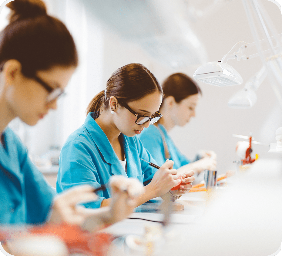 Focused scientists in blue lab coats