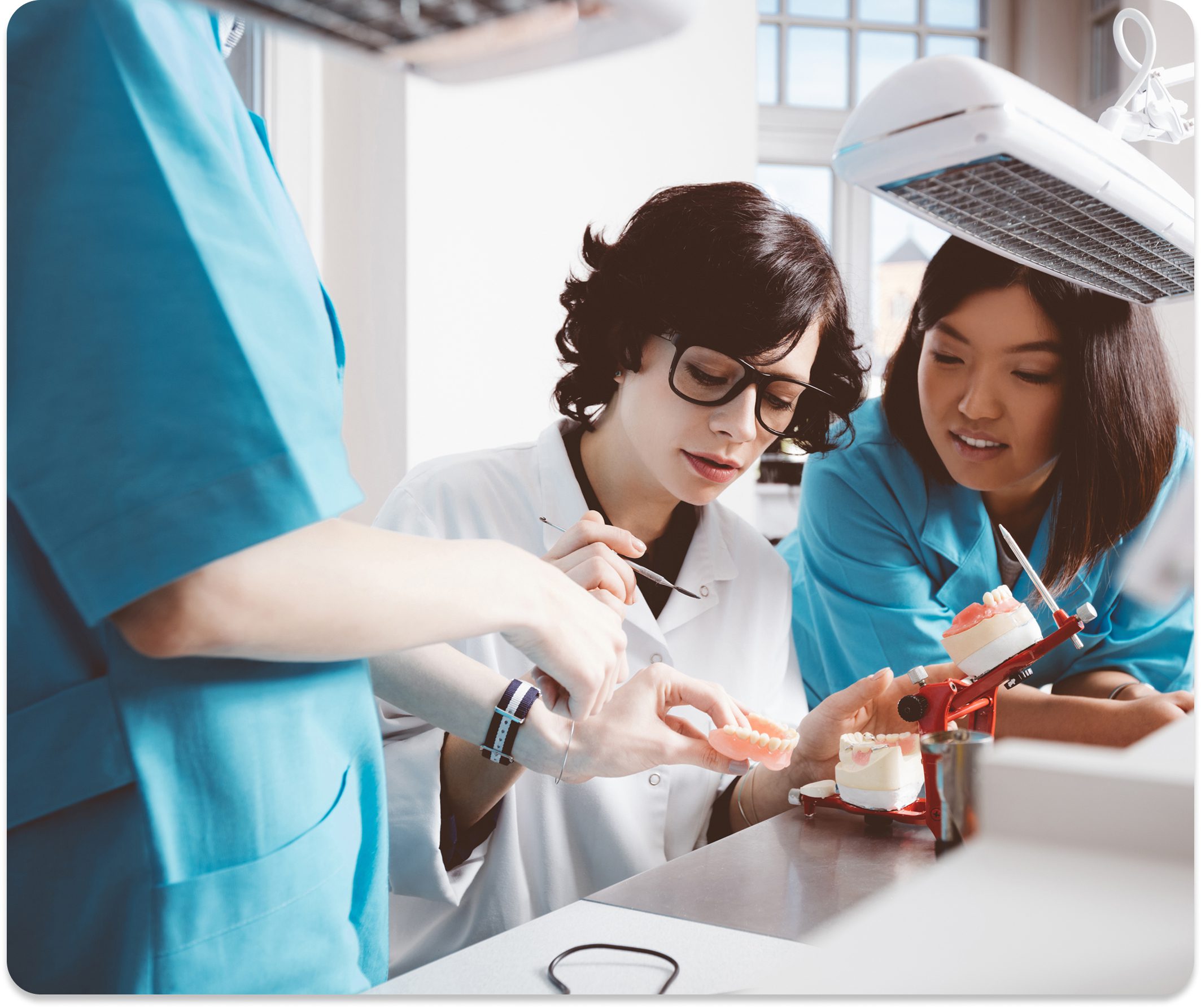 Students learning dental techniques together