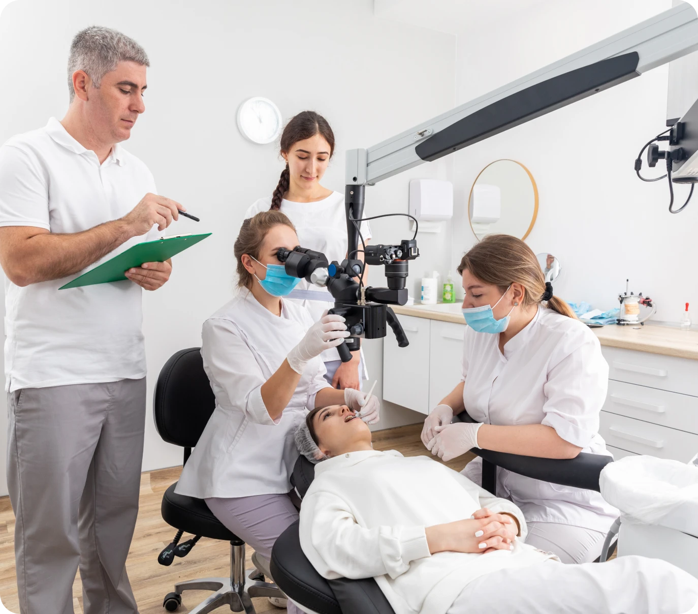 Dentist and team examining patient